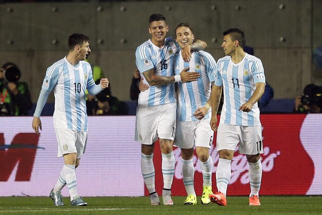 Argentina's Marcos Rojo, second left, celebrates after scoring against Paraguay with teammates Lionel Messi, left, Lucas Biglia, second right, and Sergio Aguero, right, during a Copa America semifinal soccer match at the Ester Roa Rebolledo Stadium in Concepcion, Chile, Tuesday, June 30, 2015. (AP Photo/Ricardo Mazalan)