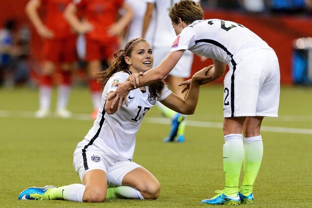 MONTREAL, QC - JUNE 30:  Alex Morgan #13 of the United States reacts with teammate Meghan Klingenberg #22 after Morgan was fouled in the box in the second half against Germany in the FIFA Women's World Cup 2015 Semi-Final Match at Olympic Stadium on June 30, 2015 in Montreal, Canada.  (Photo by Minas Panagiotakis/Getty Images)