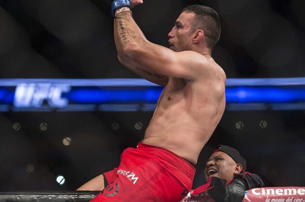 Brazil´s Fabricio Werdum, top, celebrates after beating United States´ Cain Velasquez in a men's mixed martial arts UFC 188 heavyweight title fight in Mexico City, Saturday, June  13, 2015. Werdum won the fight by submission. (AP Photo/Christian Palma)