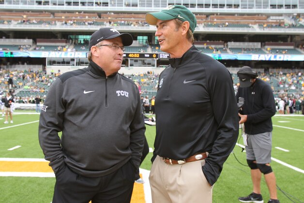 Baylor coach Art Briles, right and TCU Gary Patterson talks before their NCAA college football game, Saturday, Oct. 11, 2014, in Waco, Texas. (AP Photo/Jerry Larson)