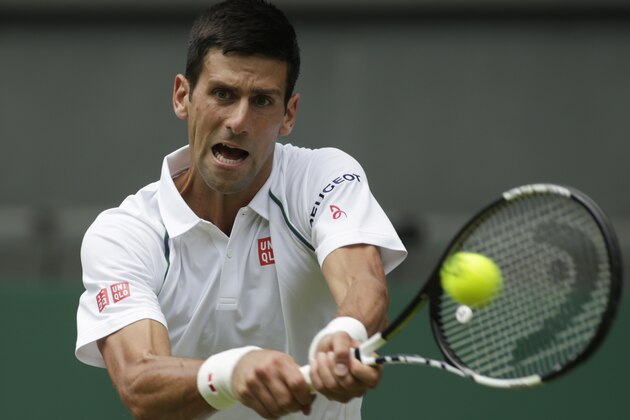 Novak Djokovic of Serbia plays a return to Jarkko Nieminen of Finland, during their singles match at the All England Lawn Tennis Championships in Wimbledon, London, Wednesday July 1, 2015. (AP Photo/Alastair Grant)