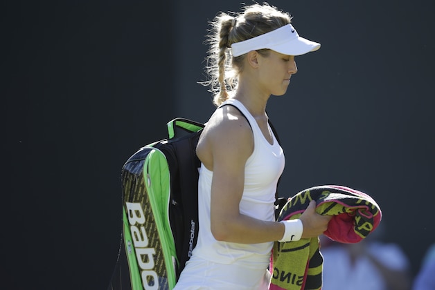 Eugenie Bouchard of Canada leaves the court after losing to Ying-Ying Duan of China in the singles first round match at the All England Lawn Tennis Championships in Wimbledon, London, Tuesday June 30, 2015. (AP Photo/Pavel Golovkin)
