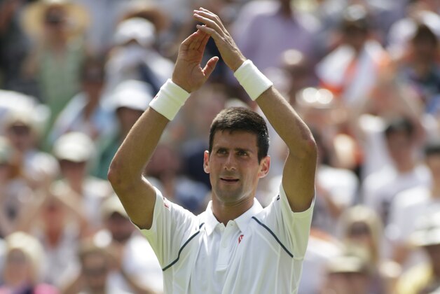 Novak Djokovic of Serbia celebrates after winning the singles match against Jarkko Nieminen of Finland, at the All England Lawn Tennis Championships in Wimbledon, London, Wednesday July 1, 2015. Djokovic won 6-4, 6-2, 6-3. (AP Photo/Alastair Grant)