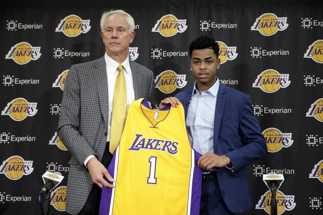 Los Angeles Lakers draft pick D'Angelo Russell, right, and general manager Mitch Kupchak pose for photos during a news conference, Monday, June 29, 2015, in El Segundo, Calif. Russell, the No. 2 NBA draft pick, was joined by fellow draftees Larry Nance Jr. and Anthony Brown. (AP Photo/Jae C. Hong)