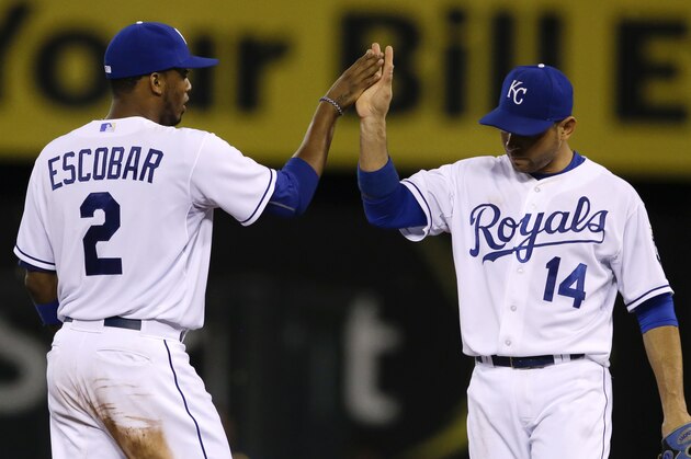 Kansas City Royals shortstop Alcides Escobar (2) celebrates with second baseman Omar Infante (14) following a baseball game against the Milwaukee Brewers at Kauffman Stadium in Kansas City, Mo., Wednesday, June 17, 2015. The Royals defeated the Brewers 10-2. (AP Photo/Orlin Wagner) Kansas City Royals shortstop Alcides Escobar (2) celebrates with second baseman Omar Infante (14) following a baseball game against the Milwaukee Brewers at Kauffman Stadium in Kansas City, Mo., Wednesday, June 17, 2015. The Royals defeated the Brewers 10-2. (AP Photo/Orlin Wagner)