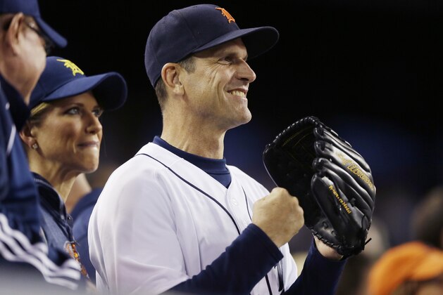 Michigan football coach Jim Harbaugh watches from the stands during the seventh inning of a baseball game between the Detroit Tigers and the Pittsburgh Pirates, Tuesday, June 30, 2015, in Detroit. (AP Photo/Carlos Osorio)