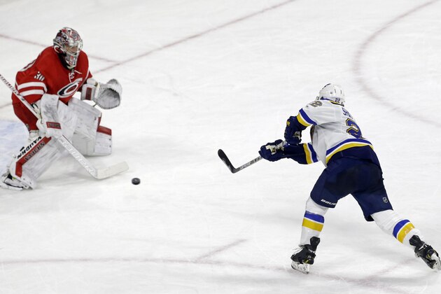 St. Louis Blues' Kevin Shattenkirk (22) scores against Carolina Hurricanes goalie Cam Ward in the shootout of an NHL hockey game in Raleigh, N.C., Friday, Jan. 30, 2015. St. Louis won 3-2. (AP Photo/Gerry Broome)