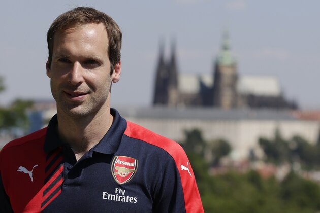 Czech Republic's goalkeeper Petr Cech smiles after a press conference in Prague, Czech Republic, Wednesday, July 1, 2015. Goalkeeper Cech ended his trophy-filled, 11-year stay at Chelsea by signing for Premier League rival Arsenal on Monday, June 29, 2015 after losing his starting place at the English champions. Prague Castle is in the background. (AP Photo/Petr David Josek)