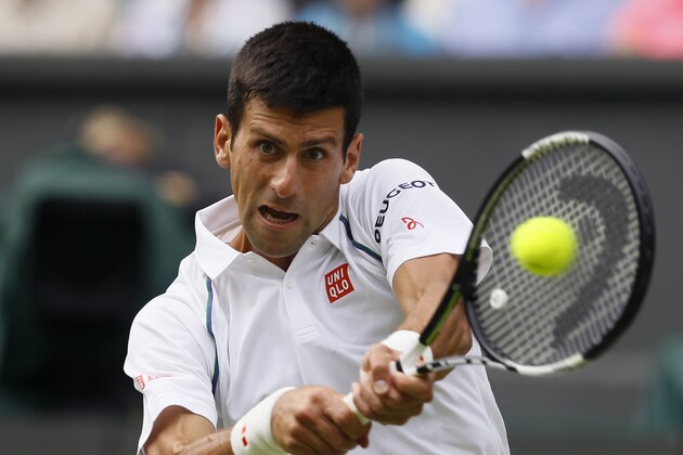 Novak Djokovic of Serbia makes a return to Bernard Tomic of Australia during their singles match at the All England Lawn Tennis Championships in Wimbledon, London, Friday July 3, 2015. (AP Photo/Kirsty Wigglesworth)