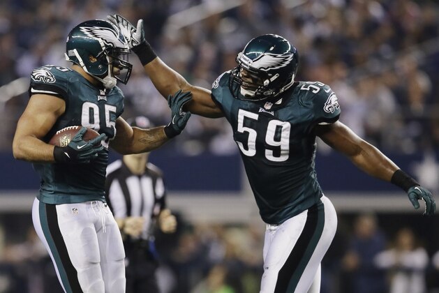 After intercepting the ball from Dallas Cowboys quarterback Kyle Orton (18), Philadelphia Eagles inside linebacker Mychal Kendricks (95) celebrates with inside linebacker DeMeco Ryans (59) during the first half of an NFL football game, Sunday, Dec. 29, 2013, in Arlington, Texas. (AP Photo/Tony Gutierrez)