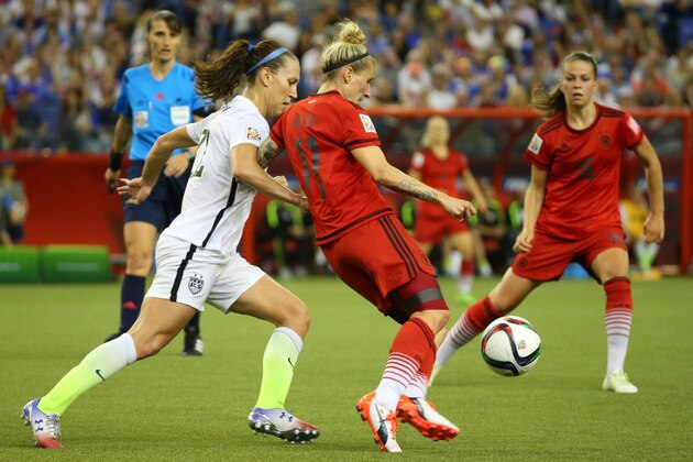 Jun 30, 2015; Montreal, Quebec, CAN; Germany midfielder Anja Mittag (11) works the ball ahead of United States midfielder Lauren Holiday (12) during the first half of the semifinals of the FIFA 2015 Women's World Cup at Olympic Stadium. Mandatory Credit: Jean-Yves Ahern-USA TODAY Sports