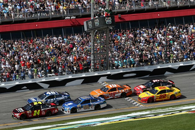 DAYTONA BEACH, FL - FEBRUARY 22:  Jeff Gordon, driver of the #24 Drive To End Hunger Chevrolet, and Jimmie Johnson, driver of the #48 Lowe's Chevrolet, lead the field to the green flag for the running of the NASCAR Sprint Cup Series 57th Annual Daytona 500 at Daytona International Speedway on February 22, 2015 in Daytona Beach, Florida.  (Photo by Brian Lawdermilk/Getty Images)
