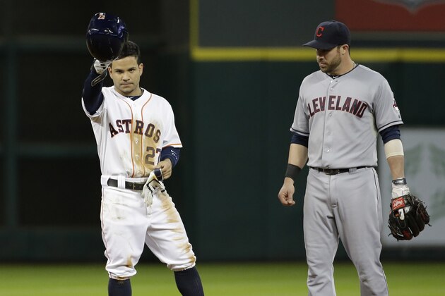 Houston Astros' Jose Altuve (27) tips his helmet after hitting a double, his 210th hit of this season, during the fifth inning of a baseball game as Cleveland Indians second baseman Jason Kipni, right, watches Tuesday, Sept. 16, 2014, in Houston. Altuve's hit ties the Astros franchise single-season hits record held by Craig Biggio. (AP Photo/David J. Phillip)
