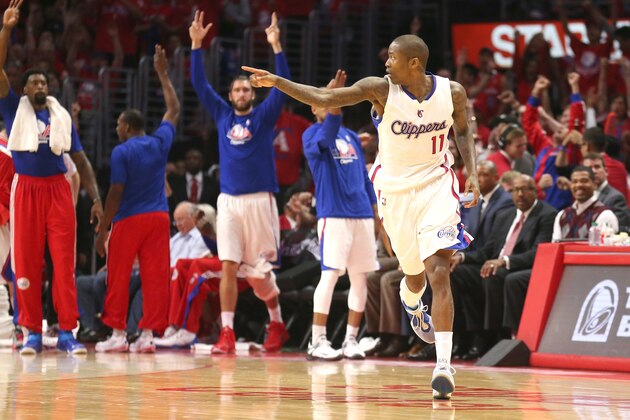 LOS ANGELES, CA - APRIL 19: Jamal Crawford #11 of the Los Angeles Clippers points after making a three point basket as teammates celebrate on the bench against the San Antonio Spurs during Game One of the Western Conference quarterfinals of the 2015 NBA Playoffs at Staples Center on April 19, 2015 in Los Angeles, California.  The Clippers won 107-92. NOTE TO USER: User expressly acknowledges and agrees that, by downloading and or using this photograph, User is consenting to the terms and conditions of the Getty Images License Agreement.  (Photo by Stephen Dunn/Getty Images)