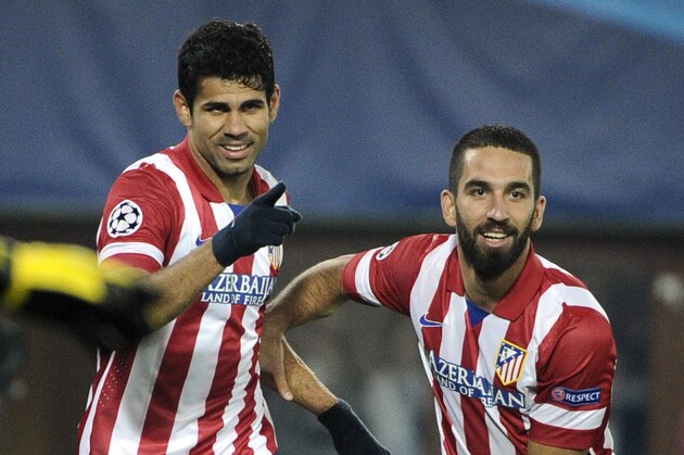 Madrid's Diego Costa, center, celebrates with Arda Turan after scoring during their Champions League third round group G soccer match between FK Austria Wien and Atletico Madrid in Vienna, Austria, Tuesday, Oct. 22, 2013. (AP Photo/Hans Punz)