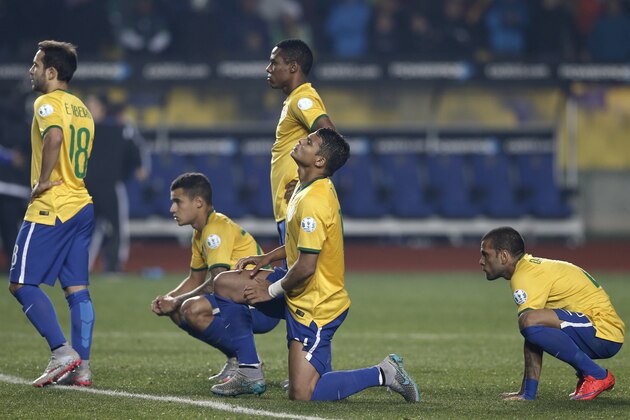 Brazil's Thiago Silva, kneeling on the pitch, reacts during the penalty shoot out at the end of  a Copa America quarterfinal soccer match at the Ester Roa Rebolledo Stadium in Concepcion, Chile, Saturday, June 27, 2015. Paraguay defeated Brazil 4-3 in a penalty shoot out after the game ended in a 1-1 draw. (AP Photo/Silvia Izquierdo)