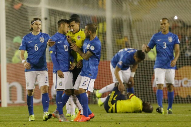 Brazil's Neymar, center left, argues with Colombia's Jeison Murillo, center right, after Neymar threw the ball at Colombia's Pablo Armero, on ground behind, at the end of a Copa America Group C soccer match at the Monumental stadium in Santiago, Chile, Wednesday, June 17, 2015. Neymar was issued a red card after the incident and suspended on Friday from the next four games, which will make him miss the rest of the tournament. (AP Photo/Ricardo Mazalan)