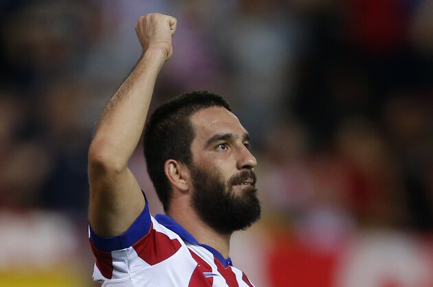 Atletico's Arda Turan celebrates after scoring during the Group A Champions League soccer match between Atletico de Madrid and Juventus at the Vicente Calderon stadium in Madrid, Spain, Wednesday Oct. 1, 2014. (AP Photo/Andres Kudacki)