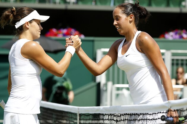 Madison Keys of the United States, right,  shakes hands after defeating Tatjana Maria of Germany in their singles match at the All England Lawn Tennis Championships in Wimbledon, London, Saturday July 4, 2015. Keys won the match 6-4, 6-4. (AP Photo/Alastair Grant)