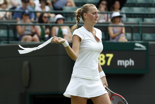 Petra Kvitova of the Czech Republic take off her headband during her singles match against Kurumi Nara of Japan, at the All England Lawn Tennis Championships in Wimbledon, London, Thursday July 2, 2015. (AP Photo/Alastair Grant)