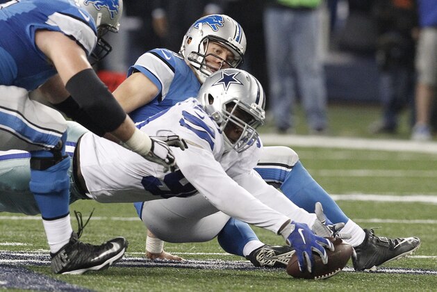 Dallas Cowboys defensive end Demarcus Lawrence (90) recovers the ball after sacking Detroit Lions quarterback Matthew Stafford (9) causing a fumble during the second half of an NFL wildcard playoff football game, Sunday, Jan. 4, 2015, in Arlington, Texas. The Cowboys won 24-20. (AP Photo/Brandon Wade)