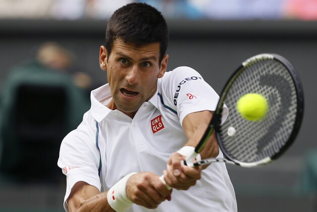 Novak Djokovic of Serbia makes a return to Bernard Tomic of Australia during their singles match at the All England Lawn Tennis Championships in Wimbledon, London, Friday July 3, 2015. (AP Photo/Kirsty Wigglesworth)