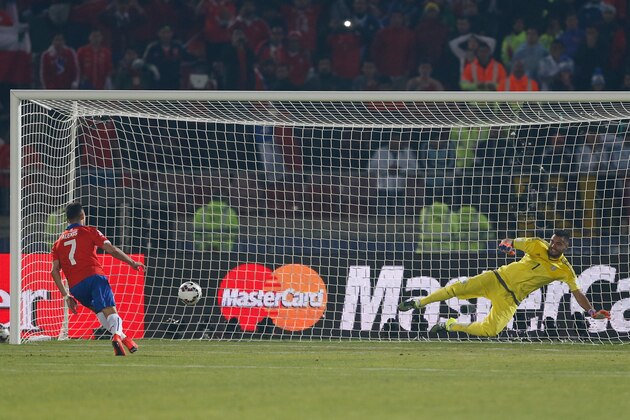 Chile's Alexis Sanchez, left, scores the winning penalty past Argentina's goalkeeper Sergio Romero  during a penalty shoot out at the end of the Copa America final soccer match at the National Stadium in Santiago, Chile, Saturday, July 4, 2015. (AP Photo/Andre Penner)