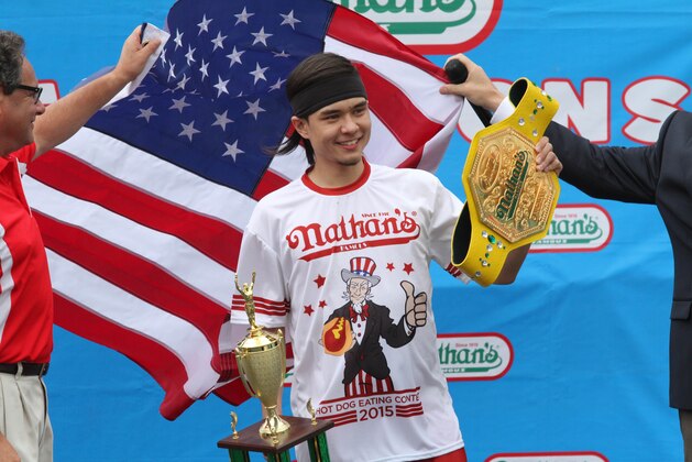 Matt Stonie poses for photographs after winning Nathan's Famous Fourth of July International Hot Dog Eating Contest men's competition, Saturday July 4, 2015 in the Coney Island section in the Brooklyn borough of New York. Stonie ate 62 hot dogs and buns in 10 minutes. (AP Photo/Tina Fineberg)