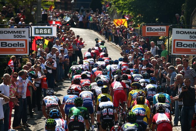 HUY, BELGIUM - APRIL 23:  The peloton climb the Mur de Huy during the 78th edition of the La Fleche Wallonne on April 23, 2014 in Huy, Belgium. The 199km parcours scales the Mur de Huy climb three times, with the final 9.3% average ascent providing the finish to the race.  (Photo by Bryn Lennon - Velo/Getty Images)