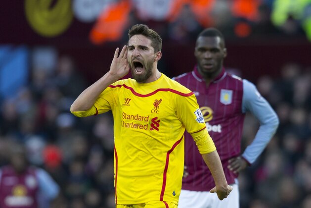 Liverpool's Fabio Borini, left, celebrates as Aston Villa's Christian Benteke looks on during the English Premier League soccer match between Aston Villa and Liverpool at Villa Park Stadium, Birmingham, England, Saturday Jan. 17, 2015. (AP Photo/Jon Super)