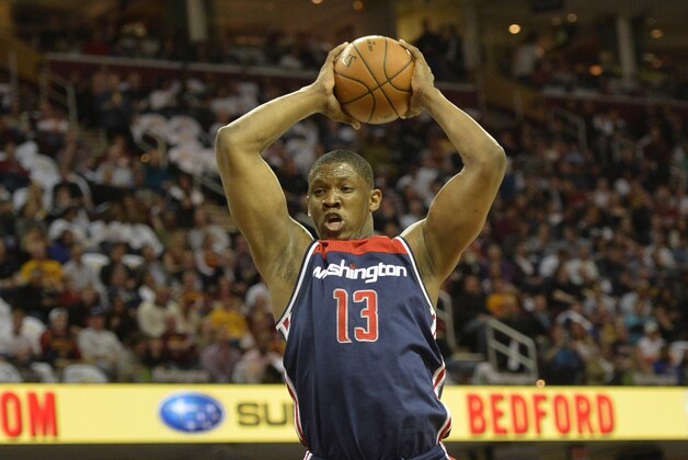 Apr 15, 2015; Cleveland, OH, USA; Washington Wizards center Kevin Seraphin (13) rebounds in the second quarter against the Cleveland Cavaliers at Quicken Loans Arena. Mandatory Credit: David Richard-USA TODAY Sports