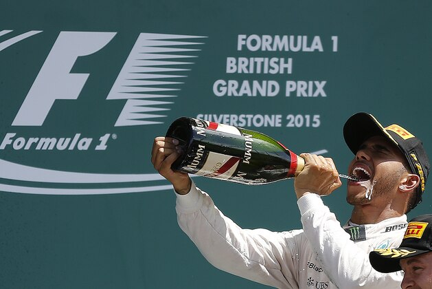 British Mercedes driver Lewis Hamilton celebrates after winning the British Formula One Grand Prix at Silverstone circuit, Silverstone, England, Sunday, July 5, 2015.  (AP Photo/Frank Augstein)
