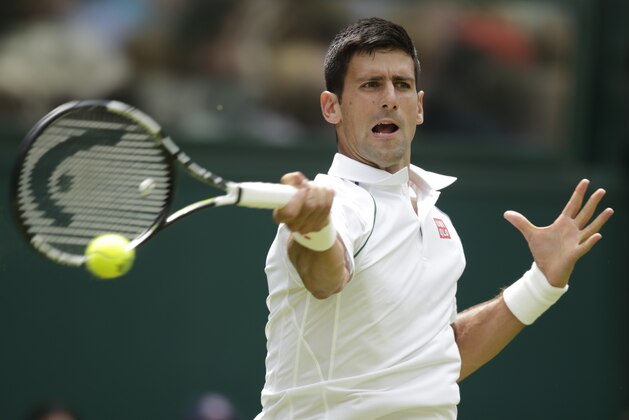 Novak Djokovic of Serbia serves to Jarkko Nieminen of Finland, during their singles match at the All England Lawn Tennis Championships in Wimbledon, London, Wednesday July 1, 2015. (AP Photo/Alastair Grant)