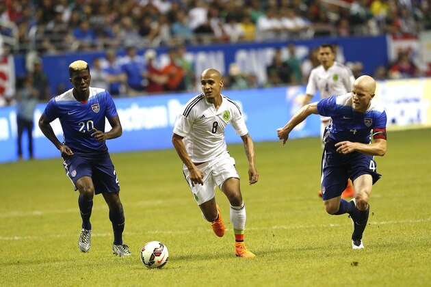 SAN ANTONIO, TX - APRIL 15:  Luis Rodriguez #8 of Mexico races for the ball between Gyasi Zardes #20 and Michael Bradley #4 of the United States during an international friendly match at the Alamodome on April 15, 2015 in San Antonio, Texas.  (Photo by Chris Covatta/Getty Images)
