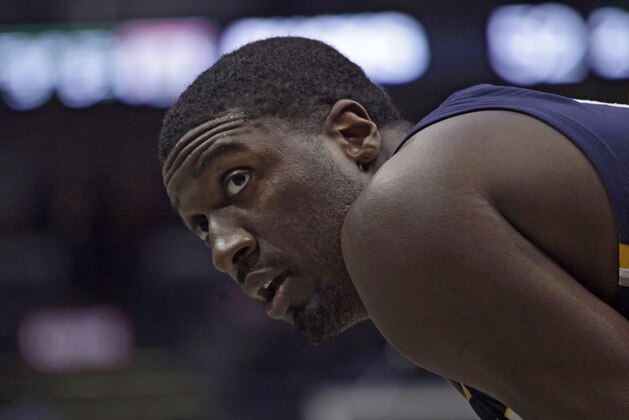 Indiana Pacers center Roy Hibbert checks the score as he waits for a free throw shot from the Milwaukee Bucks during the first half of an NBA basketball game Thursday, March 26, 2015 in Milwaukee. (AP Photo/Darren Hauck)