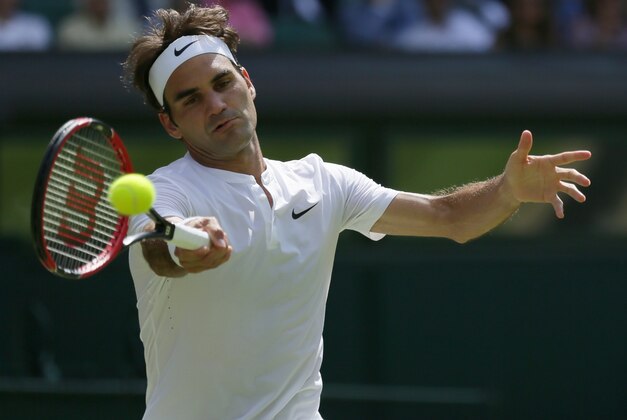 Roger Federer of Switzerland returns a shot to Sam Groth of Australia during their singles match at the All England Lawn Tennis Championships in Wimbledon, London, Saturday July 4, 2015. (AP Photo/Tim Ireland)