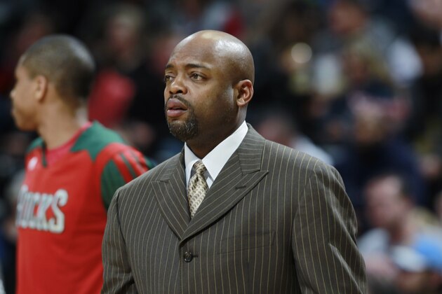 Milwaukee Bucks assistant coach Nick Van Exel looks on against the Denver Nuggets in the first quarter of an NBA basketball game in Denver on Wednesday, Feb. 5, 2014. (AP Photo/David Zalubowski)