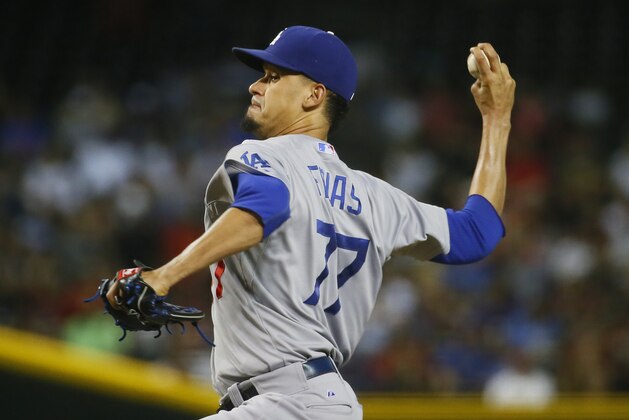 Los Angeles Dodgers starting pitcher Carlos Frias (77) throws against the Arizona Diamondbacks during the first inning of a baseball game, Tuesday, June 30, 2015, in Phoenix. (AP Photo/Matt York)