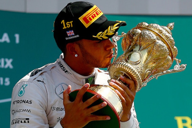 NORTHAMPTON, ENGLAND - JULY 05:  Lewis Hamilton of Great Britain and Mercedes GP celebrates on the podium after winning the Formula One Grand Prix of Great Britain at Silverstone Circuit on July 5, 2015 in Northampton, England.  (Photo by Dan Istitene/Getty Images)