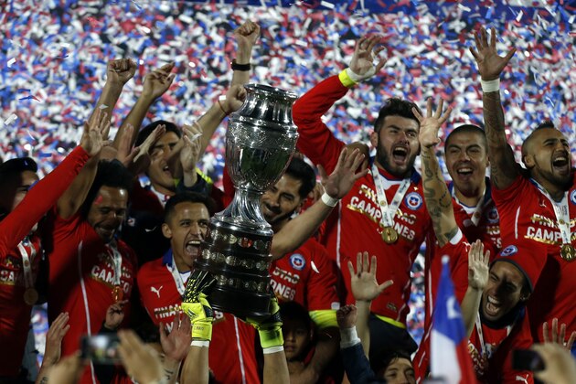 Chile's players hold up the Copa America trophy after the final soccer match against Argentina at the National Stadium in Santiago, Chile, Saturday, July 4, 2015. Chile's Bravo made a save and striker Alexis Sanchez converted the winning penalty as host Chile defeated Argentina 4-1 in a shootout after a 0-0 draw in the Copa America final on Saturday, finally winning its first major title. (AP Photo/Luis Hidalgo)
