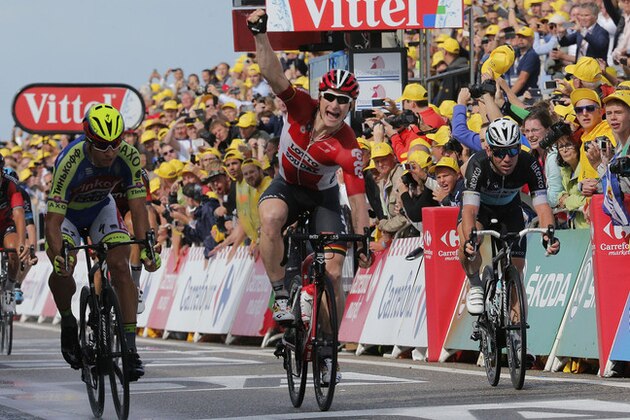 Germany's Andre Greipel crosses the finish line ahead of Peter Sagan of Slovakia, left, and Britain's sprinter Mark Cavendish, right, to win the second stage of the Tour de France cycling race over 166 kilometers (103 miles) with start in Utrecht and finish in Neeltje Jans, Netherlands, Sunday, July 5, 2015. (AP Photo/Christophe Ena)