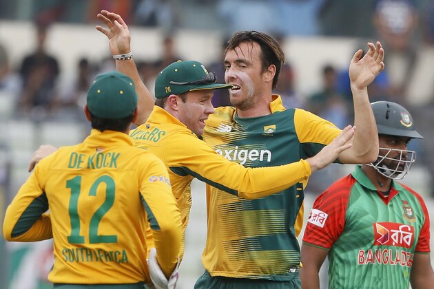 South Africa’s Kyle Abbott, second right, celebrates with his teammates AB de Villiers, second left, and Quinton de Kock after the dismissal of Bangladesh’s Tamim Iqbal, right, during their first Twenty20 international cricket match in Dhaka, Bangladesh, Sunday, July 5, 2015. (AP Photo/ A.M. Ahad)