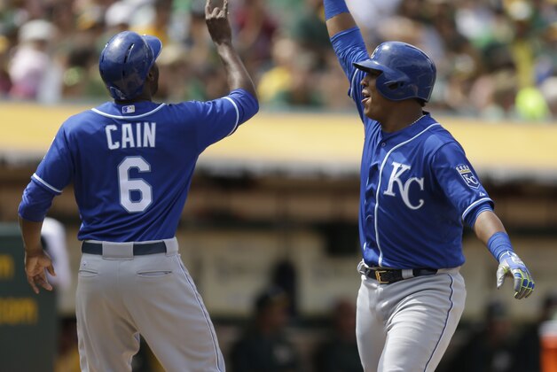 Kansas City Royals' Salvador Perez, right, celebrates with Lorenzo Cain after Perez hit a two run home run off Oakland Athletics' Edward Mujica in the eighth inning of a baseball game Sunday, June 28, 2015, in Oakland, Calif. (AP Photo/Ben Margot)