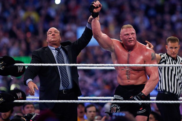 Paul Heyman, left, celebrates with Brock Lesnar after his win over the Undertaker  during Wrestlemania XXX at the Mercedes-Benz Super Dome in New Orleans on Sunday, April 6, 2014. (Jonathan Bachman/AP Images for WWE)