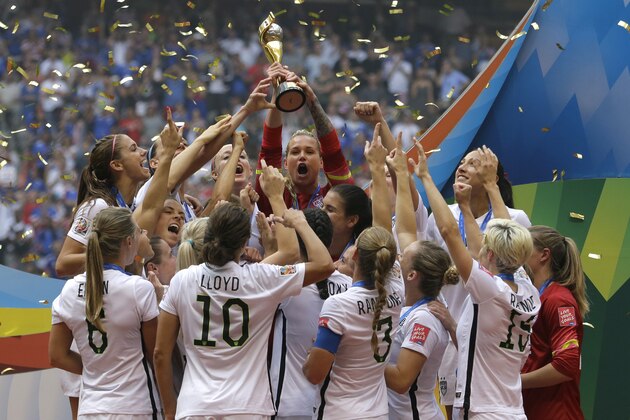 The United States Women's National Team celebrates with the trophy after they beat Japan 5-2 in the FIFA Women's World Cup soccer championship in Vancouver, British Columbia, Canada, Sunday, July 5, 2015. (AP Photo/Elaine Thompson)