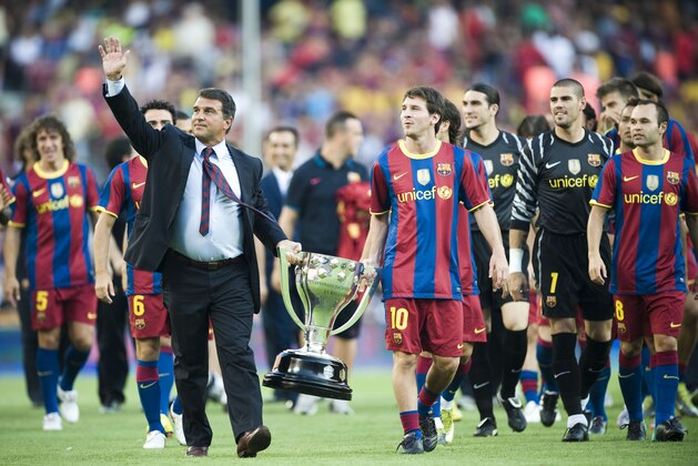 FC Barcelona former president Joan Laporta, left, and Lionel Messi from Argentina hold  the La Liga 2009-2010 season Trophy before a friendly match against AC Milan at the Camp Nou stadium in Barcelona, Spain, Wednesday, Aug. 25, 2010. (AP Photo/David Ramos)
