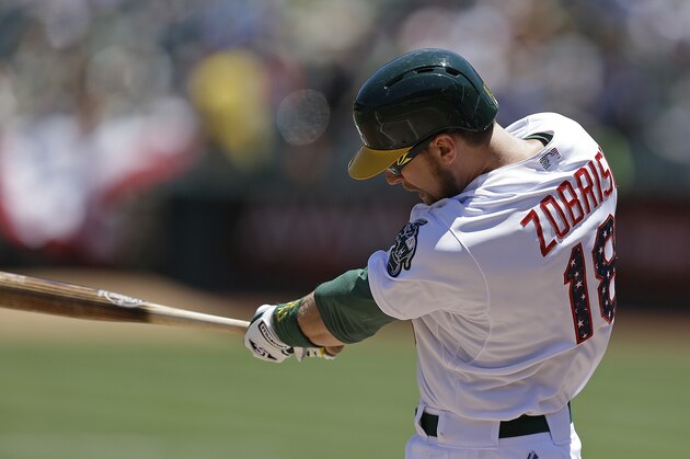 Oakland Athletics' Ben Zobrist swings for an RBI-single off Seattle Mariners' Felix Hernandez in the first inning of a baseball game Saturday, July 4, 2015, in Oakland, Calif. (AP Photo/Ben Margot)