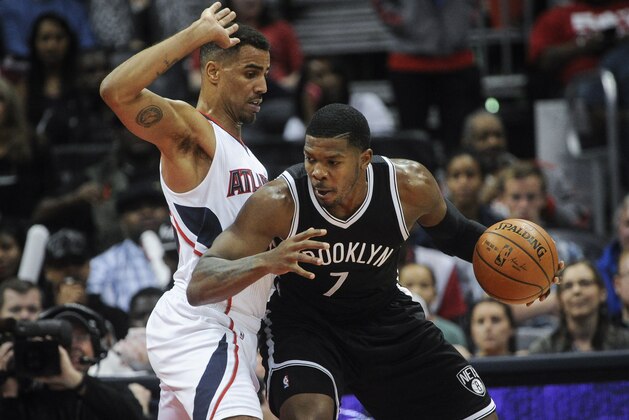 Brooklyn Nets forward Joe Johnson (7) plays against Atlanta Hawks forward Thabo Sefolosha, of Switzerland, (25) during an NBA basketball game, Saturday, April 4, 2015, in Atlanta. (AP Photo/John Amis)