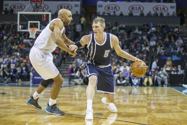 Oklahoma City Thunder forward Kyle Singler (5) dribbles the ball against Charlotte Hornets guard Gerald Henderson (9) during the second half of an NBA basketball game in Charlotte, N.C. on Saturday, Feb. 21, 2015. (AP Photo/Chris Keane)