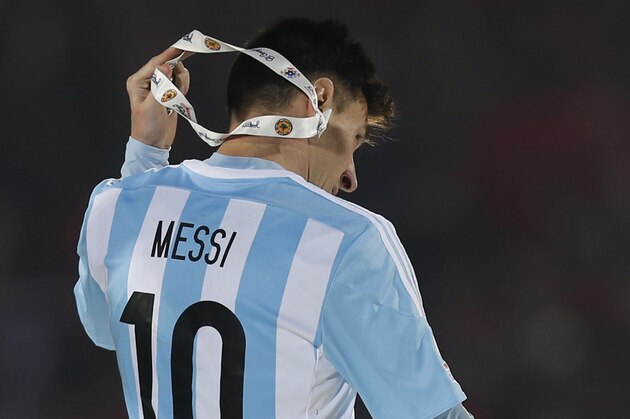 Argentina's Lionel Messi takes off the Copa America silver medal after the final game with Chile at the National Stadium in Santiago, Chile, Saturday, July 4, 2015. Chile's goalkeeper Claudio Bravo made a save and striker Alexis Sanchez converted the winning penalty as host Chile defeated Argentina 4-1 in a shootout after a 0-0 draw in the Copa America final. (AP Photo/Luis Hidalgo)